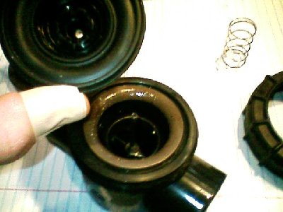 close up of valve, spring has been removed and im holding the diaphragm in my hand.
