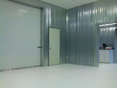 View of Kitchen and bathroon from Inside Machine room (20x34). Epoxy floor still wet.